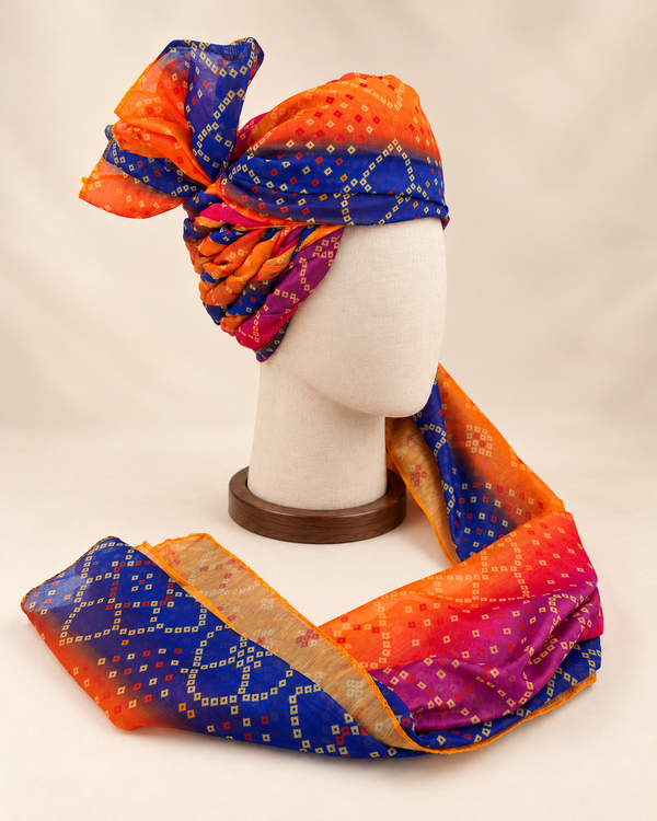 Right side view of orange royal blue multicolour bandhani Barati Safa showing twisted folds and fan