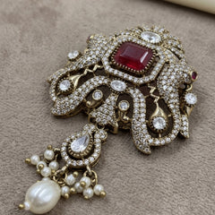 Red Ornamental Brooch with White Bead Drop, front view