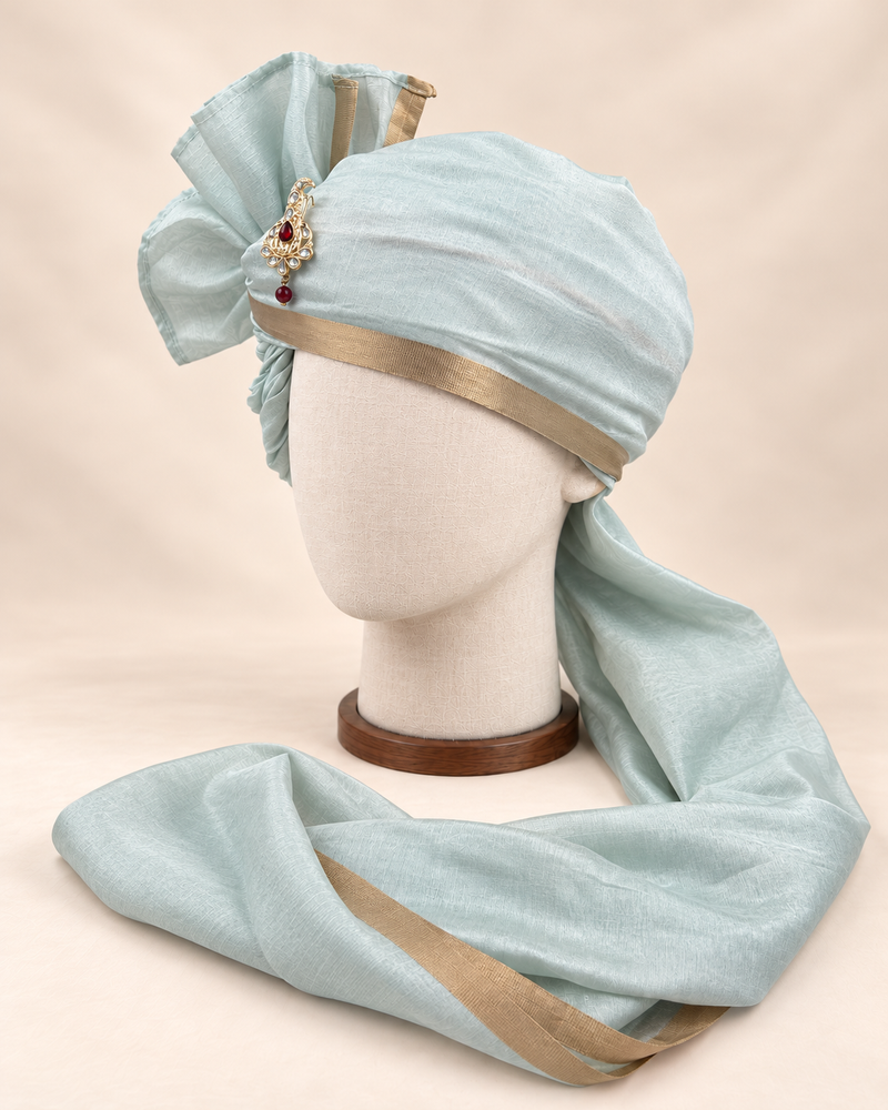 Left side view of pale sage gold border premium barati safa showing the smooth wrap and long bordered tail
