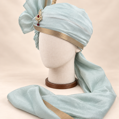 Left side view of pale sage gold border premium barati safa showing the smooth wrap and long bordered tail