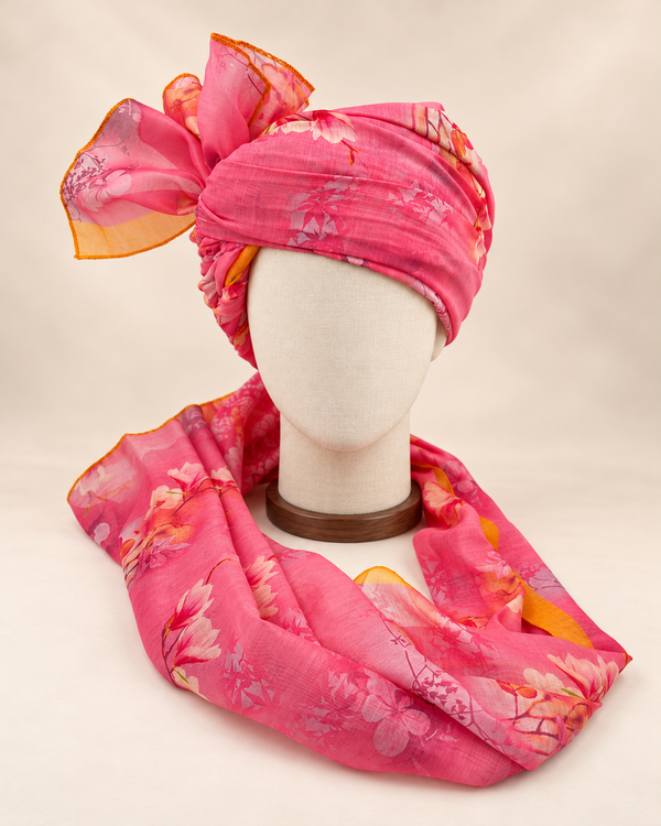 Front view of pink floral print barati safa showing the patterned wrap and fan