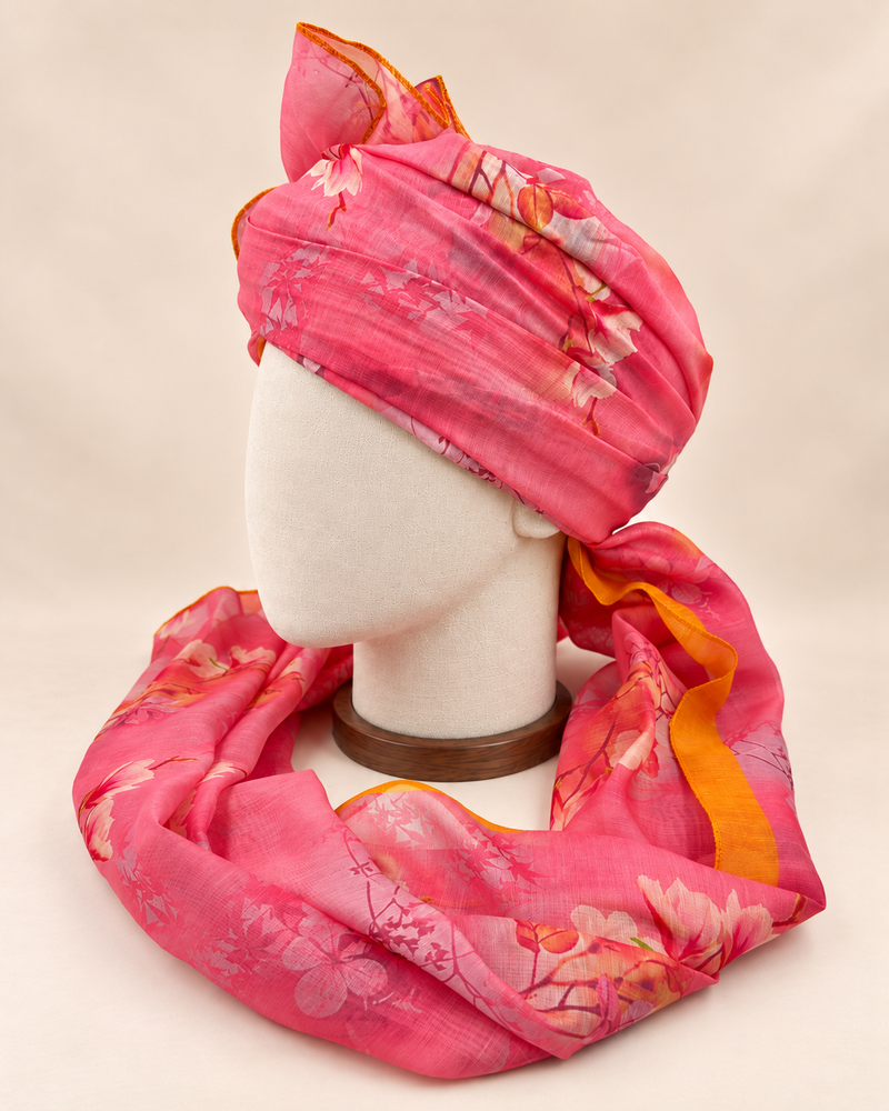 Left side view of pink floral print barati safa showing the smooth wrap and long patterned tail