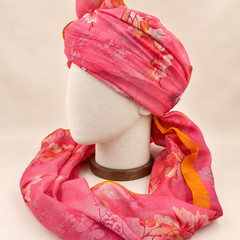 Left side view of pink floral print barati safa showing the smooth wrap and long patterned tail