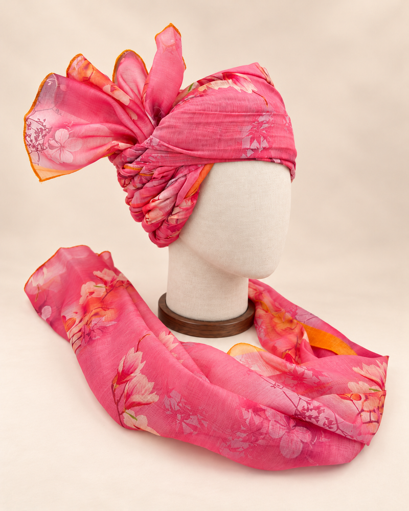 Right side view of pink floral print barati safa showing twisted folds and fan detail
