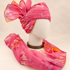 Right side view of pink floral print barati safa showing twisted folds and fan detail