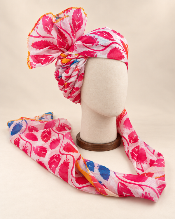 Right side view of pink white leaf print Barati Safa showing twisted folds and yellow-edged fan