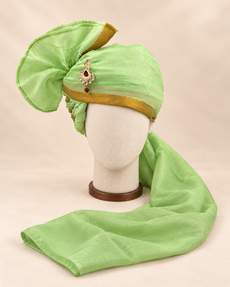 Front view of pistachio green gold border premium barati safa showing the gold-tone border and broad fan