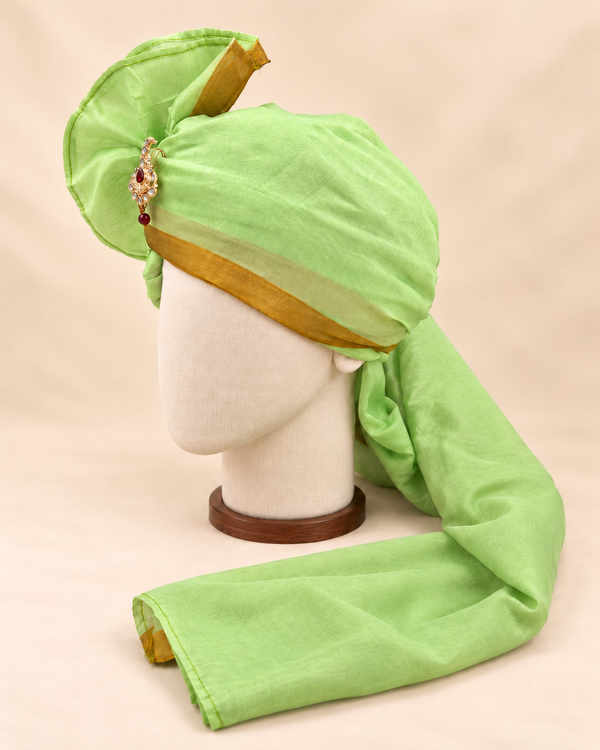 Left side view of pistachio green gold border premium barati safa showing the smooth wrap and long bordered tail
