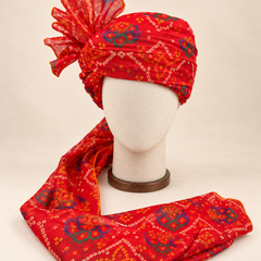 Front view of red blue bandhani print barati safa showing the patterned wrap and fan