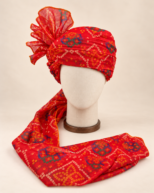 Front view of red blue bandhani print barati safa showing the patterned wrap and fan