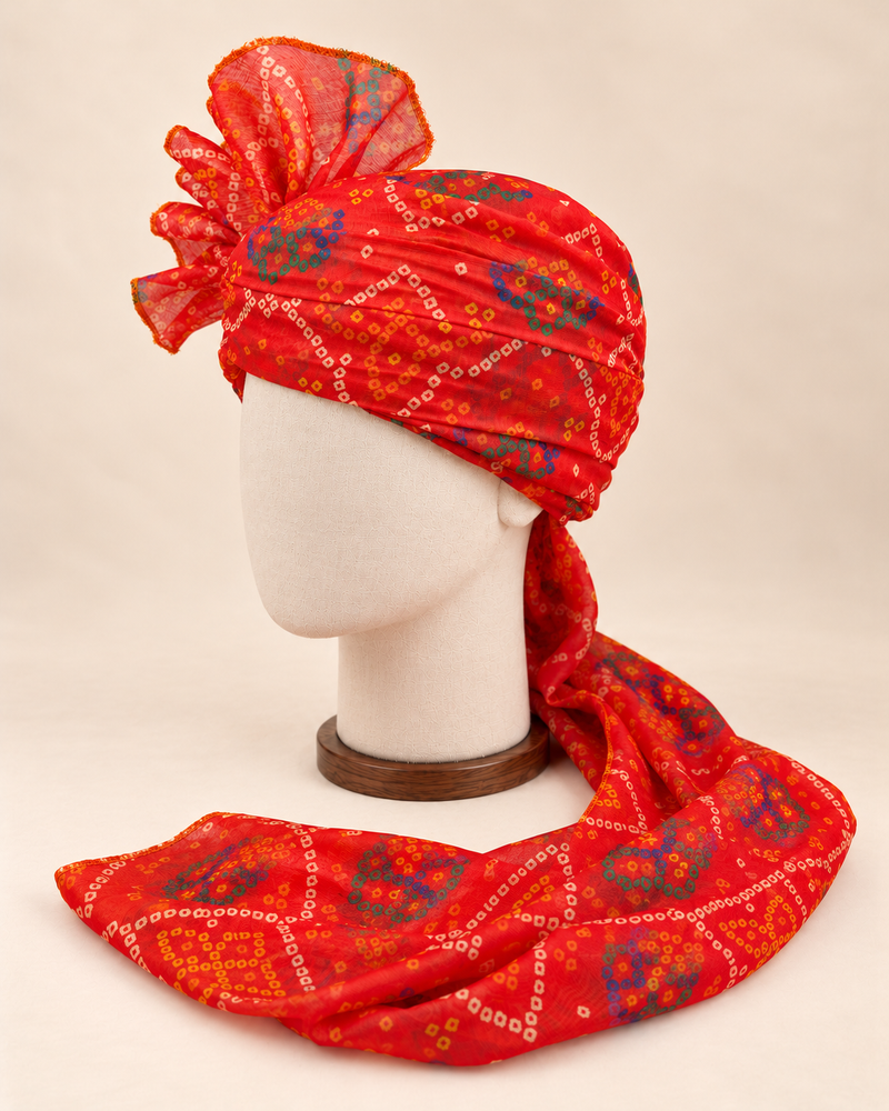 Left side view of red blue bandhani print barati safa showing the smooth wrap and long patterned tail