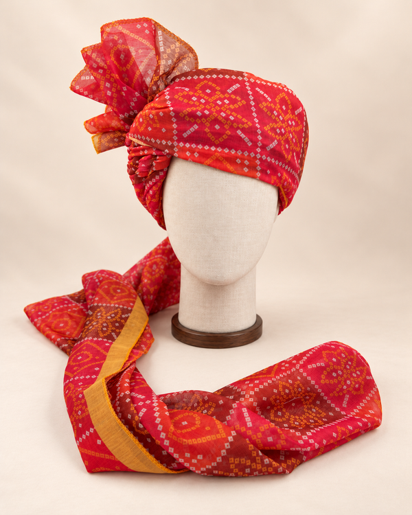 Front view of red diamond bandhani print barati safa showing the patterned wrap and fan