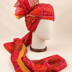 Right side view of red diamond bandhani print barati safa showing twisted folds and fan detail