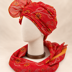 Left side view of red floral bandhani Barati Safa showing its wrap and mustard-edged patterned tail