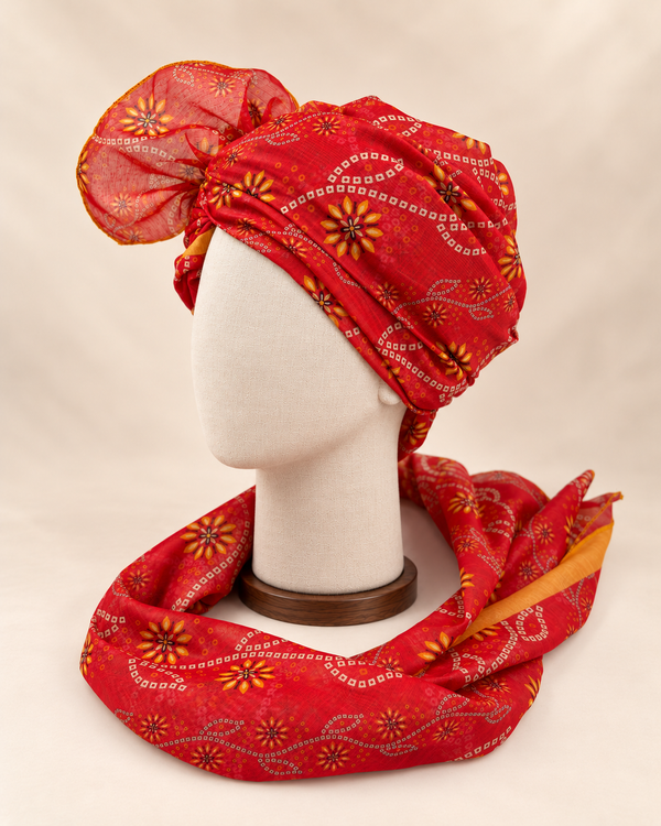 Left side view of red floral bandhani Barati Safa showing its wrap and mustard-edged patterned tail