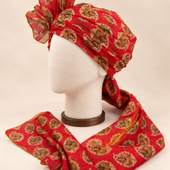 Left side view of red floral medallion Barati Safa showing its wrap and mustard-edged tail