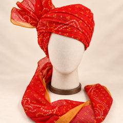 Front view of red gold paisley bandhani print barati safa showing the patterned wrap and fan