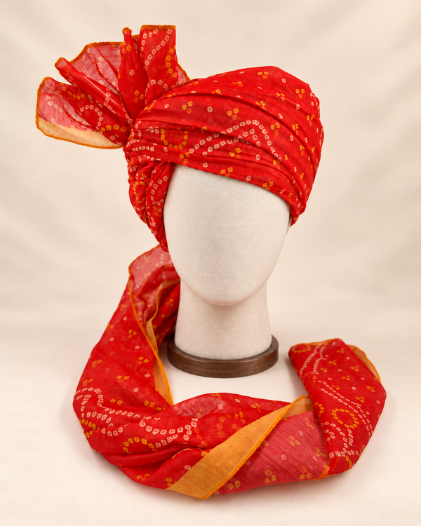 Front view of red gold paisley bandhani print barati safa showing the patterned wrap and fan