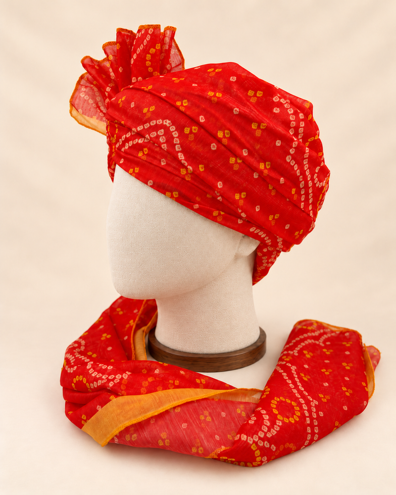 Left side view of red gold paisley bandhani print barati safa showing the smooth wrap and long patterned tail