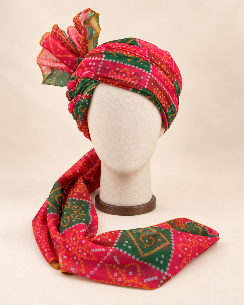 Front view of red green bandhani print barati safa showing the patterned wrap and fan