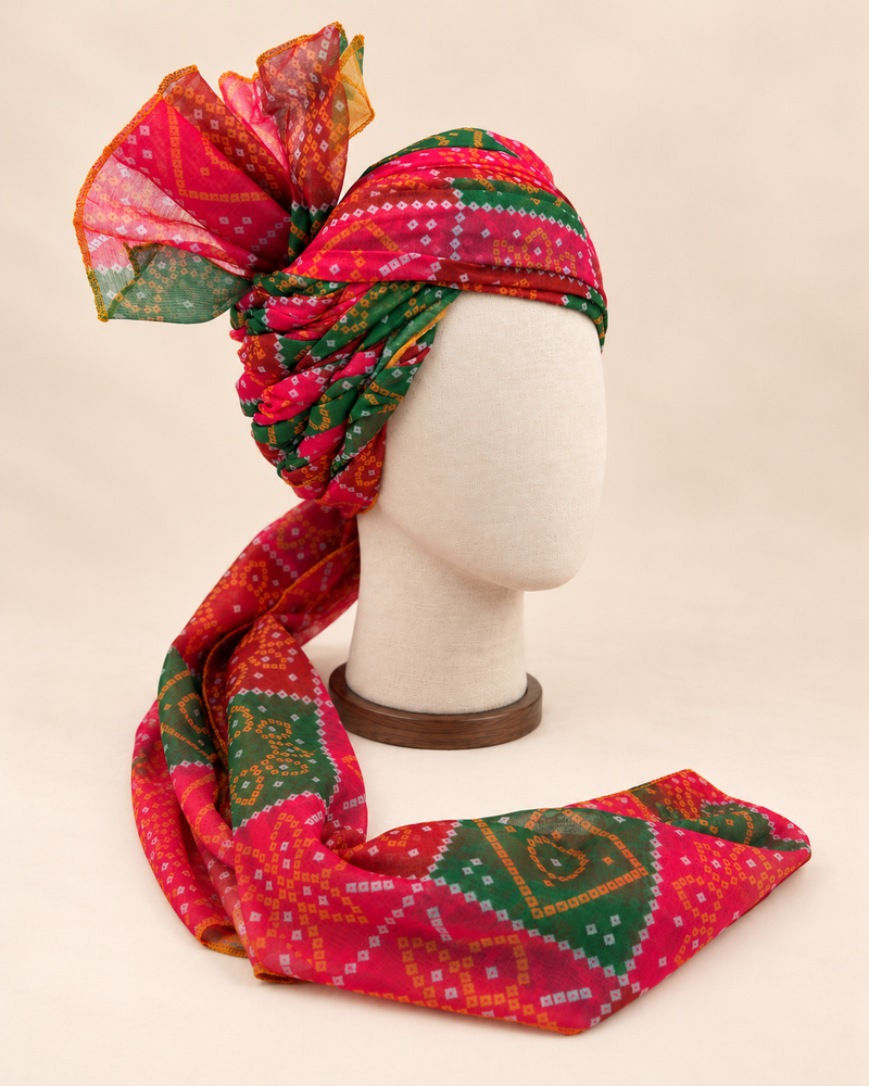 Right side view of red green bandhani print barati safa showing twisted folds and fan detail