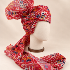 Right side view of red ikat geometric print barati safa showing twisted folds and fan detail