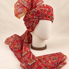 Right side view of red multicolour geometric print Barati Safa showing twisted folds and fan