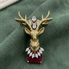 Gold-Tone Stag Head Brooch with Red Accent, front view