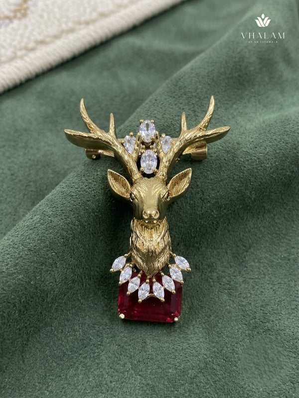 Gold-Tone Stag Head Brooch with Red Accent, front view