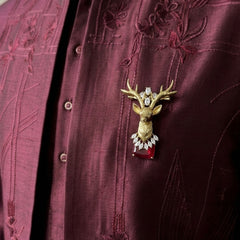Gold-Tone Stag Head Brooch with Red Accent, styled view