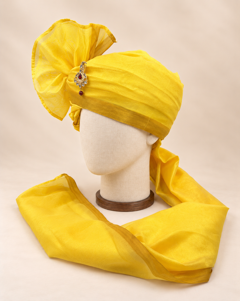 Left side view of sunshine yellow gold border premium barati safa showing the smooth wrap and long bordered tail