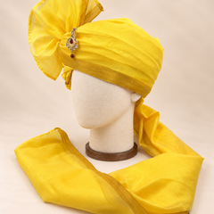 Left side view of sunshine yellow gold border premium barati safa showing the smooth wrap and long bordered tail