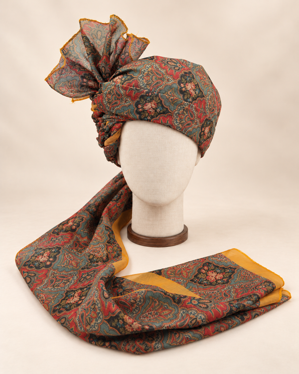 Front view of teal coral floral paisley Barati Safa with charcoal medallions and mustard border