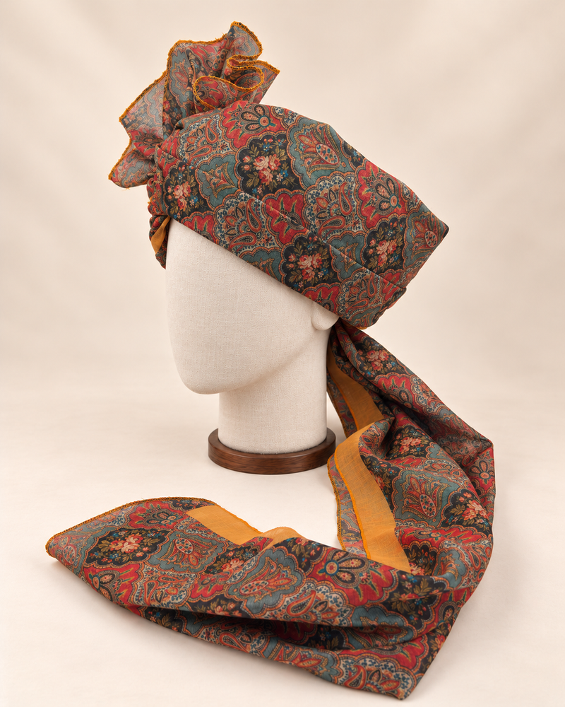 Left side view of teal coral floral paisley Barati Safa showing its wrap and mustard-bordered tail